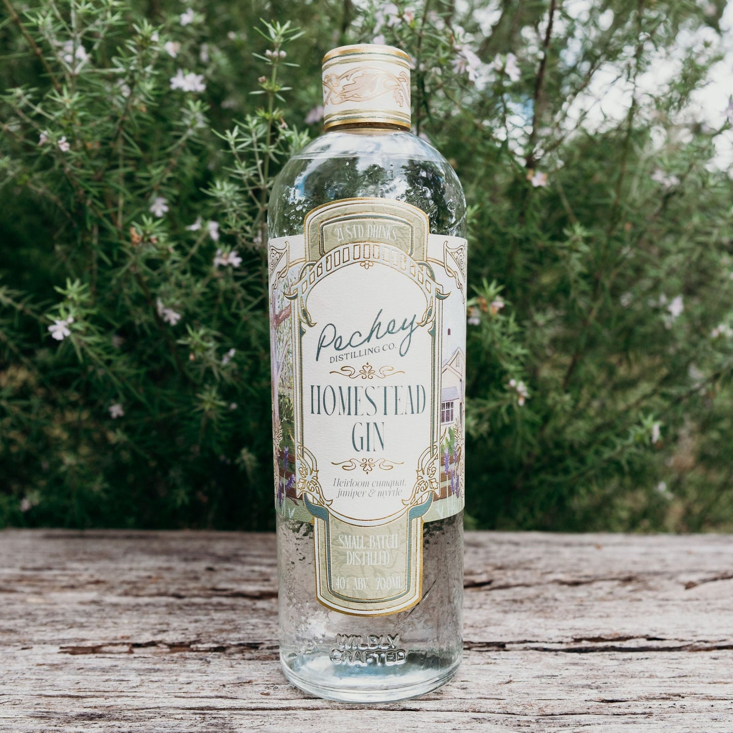 Bottle of Pechey Homestead Gin on a wooden surface with a natural background