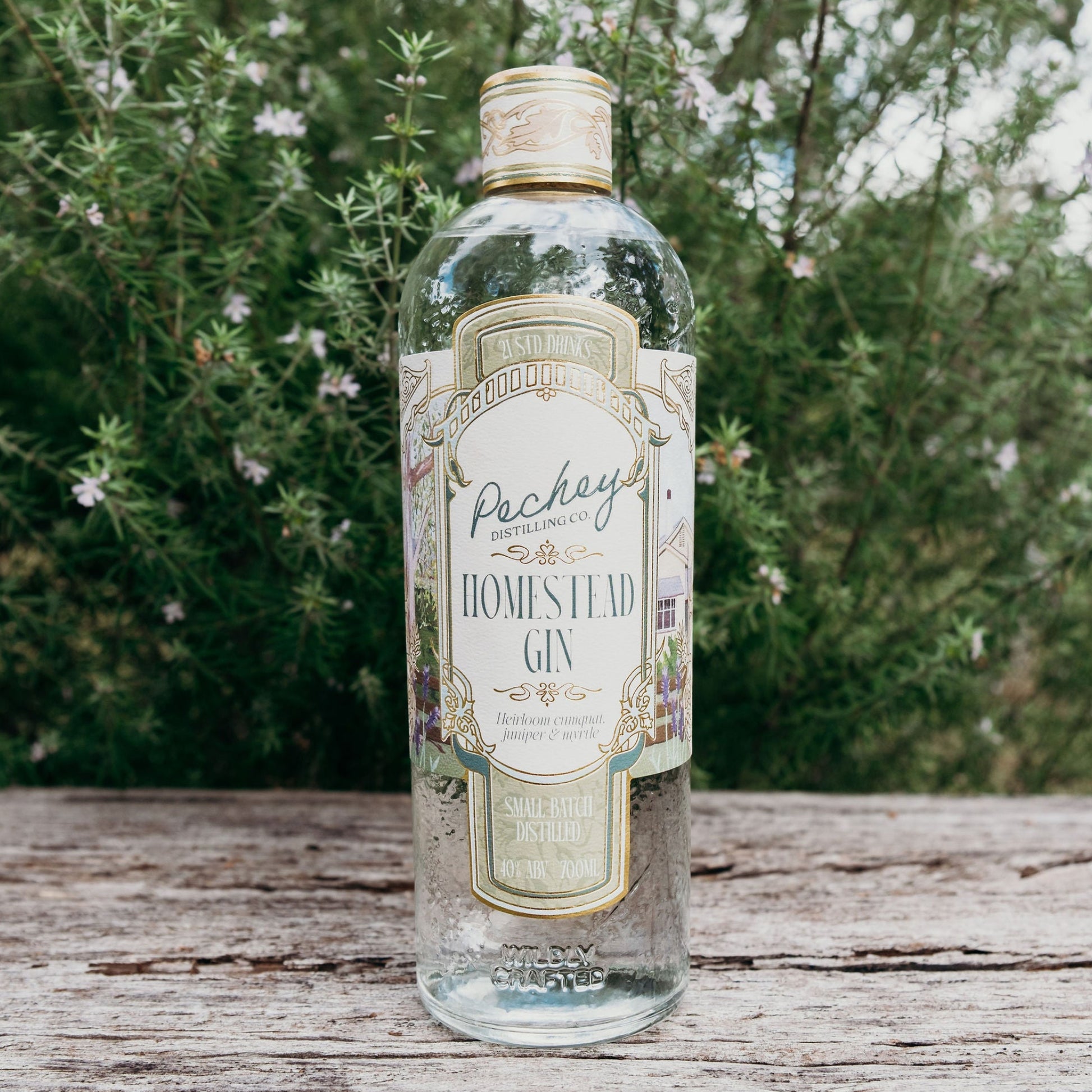 Bottle of Pechey Homestead Gin on a wooden surface with a natural background